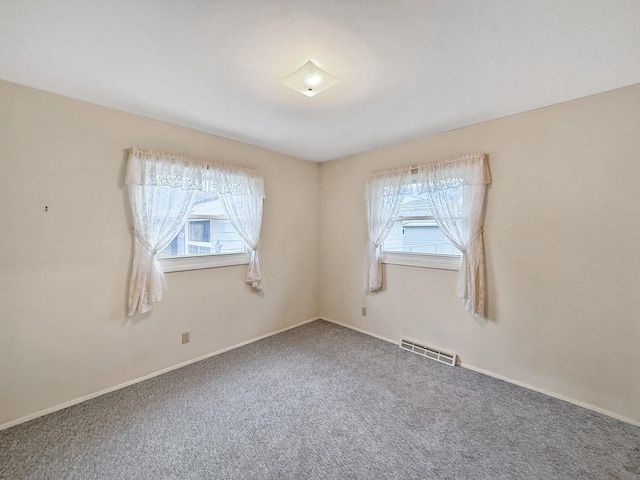 empty room with visible vents, baseboards, and carpet floors