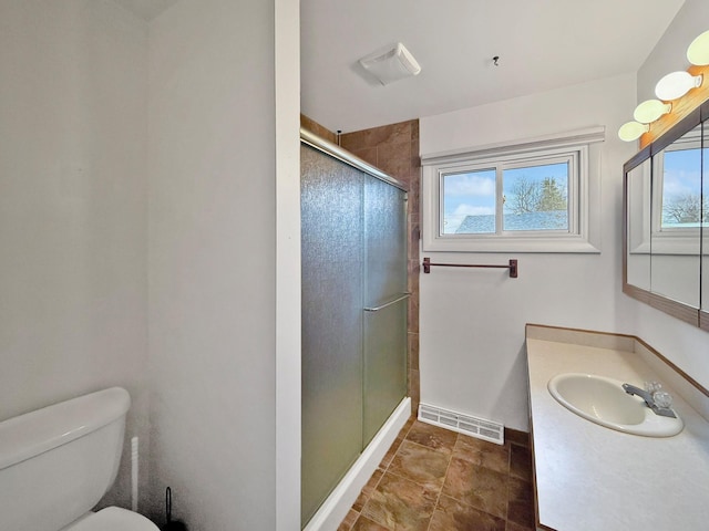 full bathroom featuring visible vents, vanity, toilet, baseboards, and a stall shower