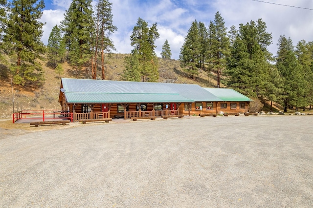 exterior space featuring a porch and log exterior