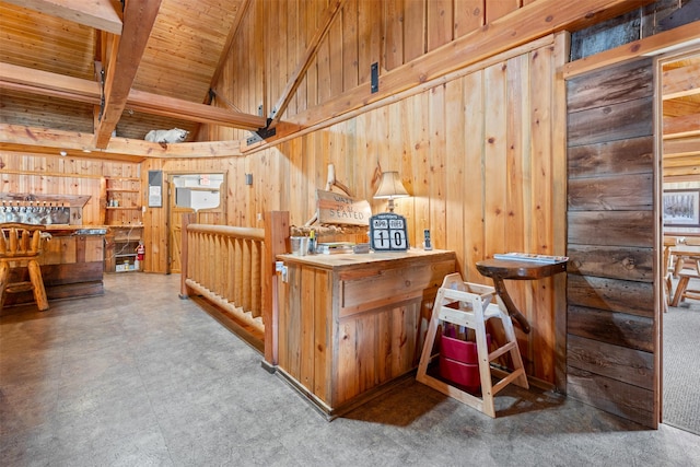 interior space with wood walls, wood ceiling, tile patterned floors, and beamed ceiling
