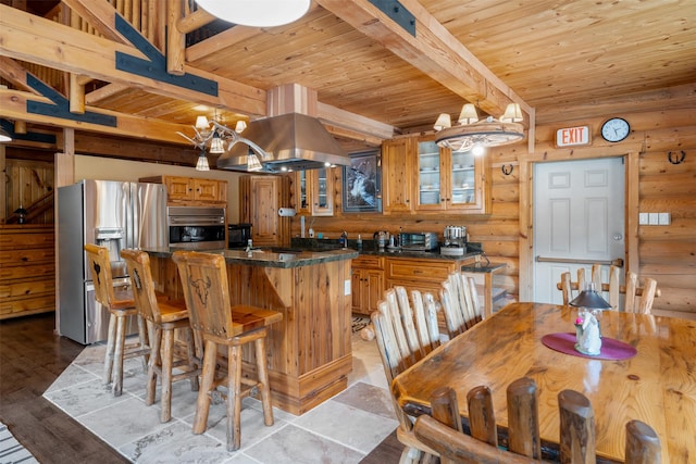 kitchen featuring stainless steel appliances, island range hood, wood ceiling, and rustic walls