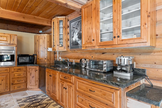 kitchen featuring appliances with stainless steel finishes, a sink, a toaster, beamed ceiling, and wood ceiling