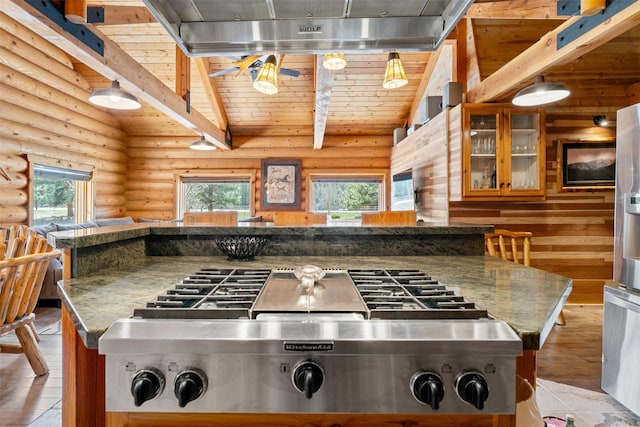 kitchen featuring stainless steel gas stovetop, log walls, light wood finished floors, and wood ceiling