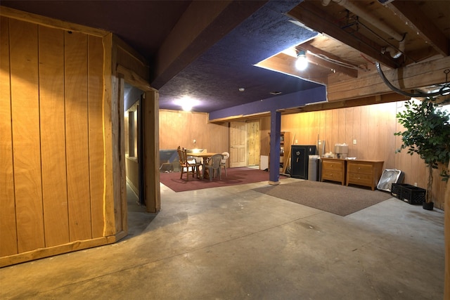 basement featuring wooden walls