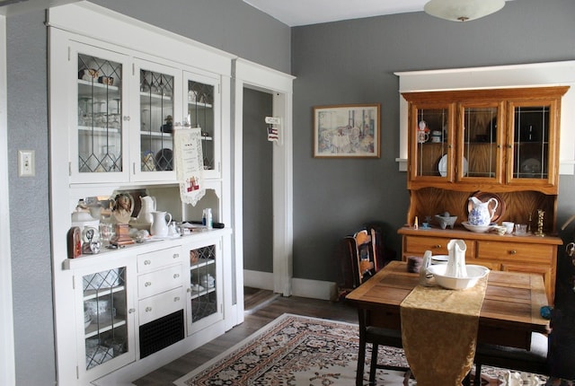 dining area featuring baseboards and wood finished floors