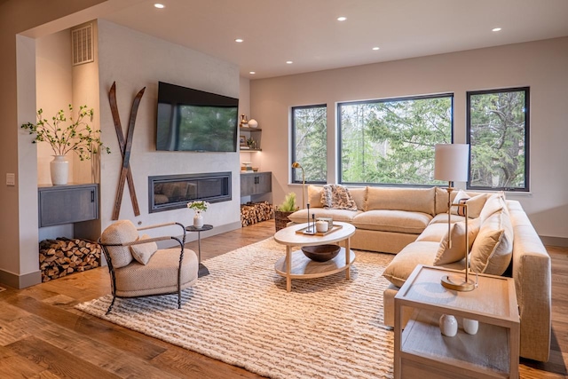living area featuring visible vents, recessed lighting, and wood finished floors