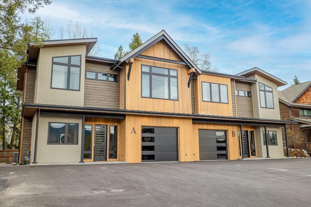 townhome / multi-family property with an attached garage and driveway