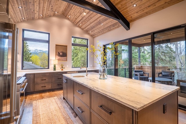 kitchen with high end range, wooden ceiling, and light wood-type flooring