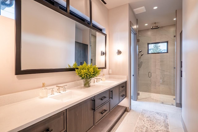 bathroom featuring a sink, a stall shower, recessed lighting, and double vanity