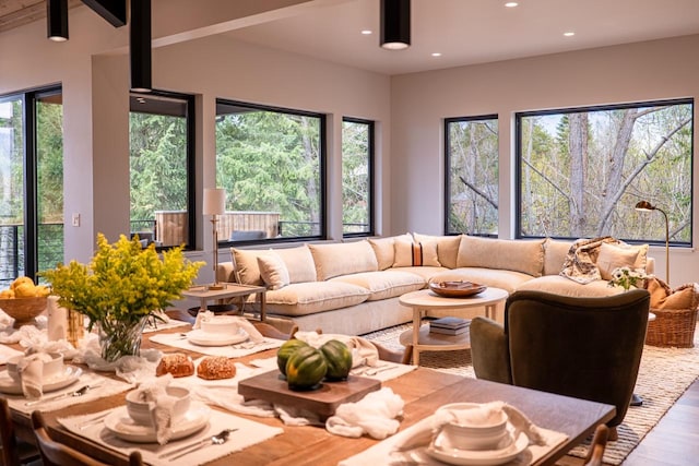 living room with beam ceiling, recessed lighting, and wood finished floors