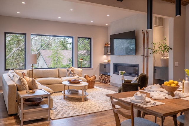 living room featuring recessed lighting, visible vents, and wood finished floors