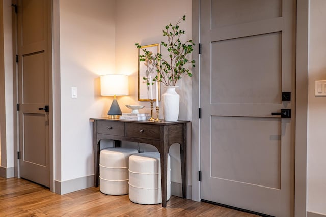 interior space featuring baseboards and wood finished floors