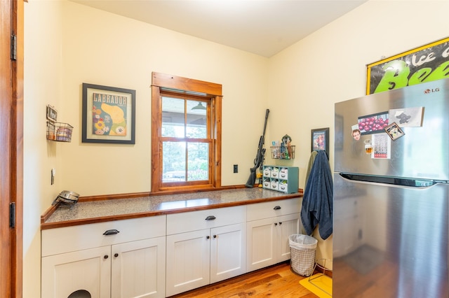 6710 Farm To Market Rd, Whitefish, MT 59937 - kitchen with freestanding refrigerator, white cabinets, light wood-style flooring, and tile countertops
