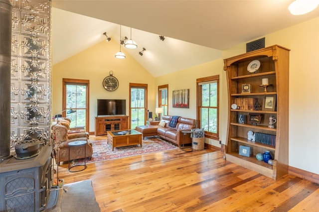 6710 Farm To Market Rd, Whitefish, MT 59937 - living room with wood-type flooring, lofted ceiling, and a wood stove