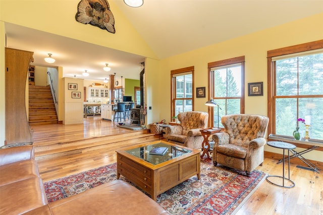 6710 Farm To Market Rd, Whitefish, MT 59937 - living area with hardwood / wood-style floors, plenty of natural light, lofted ceiling, and stairway