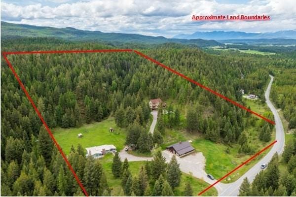 6710 Farm To Market Rd, Whitefish, MT 59937 - aerial view of property's location featuring property parcel outlined and a mountain backdrop