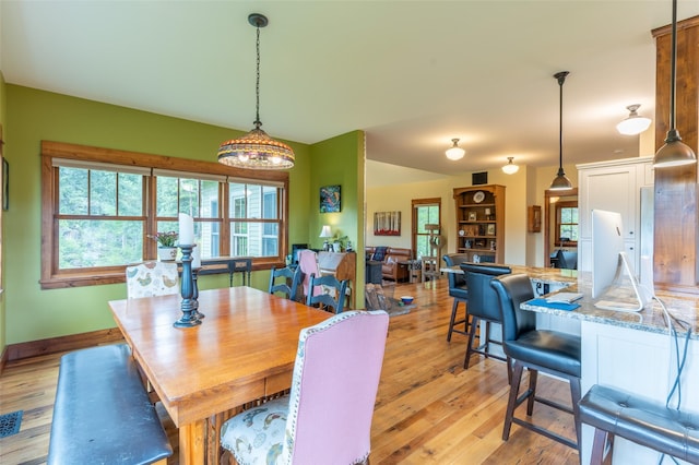 dining space with light wood-style floors and baseboards