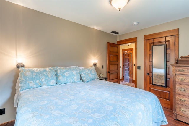 bedroom featuring visible vents and wood finished floors