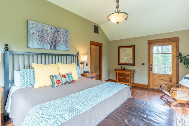 bedroom featuring baseboards, visible vents, lofted ceiling, and hardwood / wood-style flooring