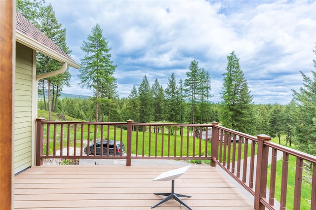 wooden terrace with a lawn