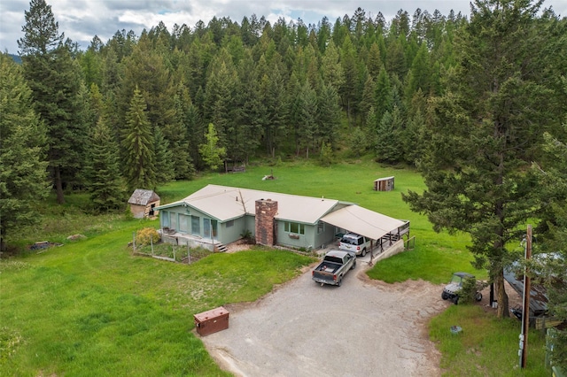 drone / aerial view featuring a forest view