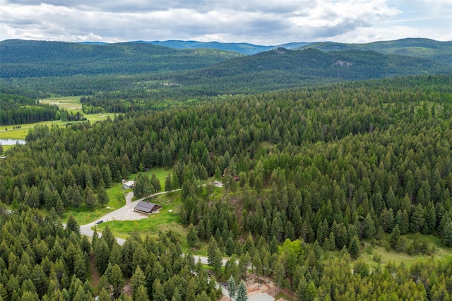 birds eye view of property with a mountain view and a wooded view