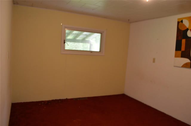 empty room featuring dark colored carpet