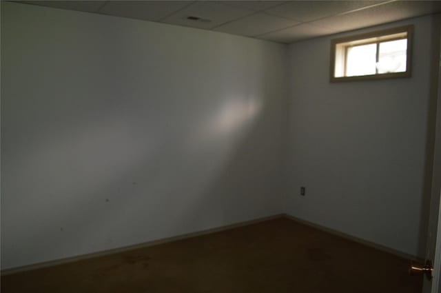 spare room with baseboards, visible vents, and a paneled ceiling