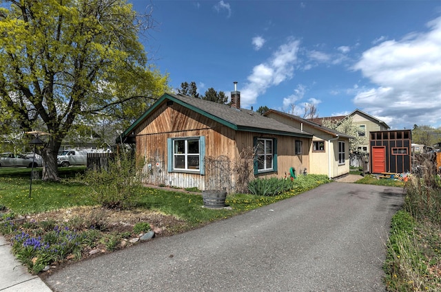 bungalow-style home featuring a chimney