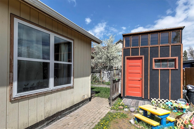 view of outbuilding with fence and an outdoor structure