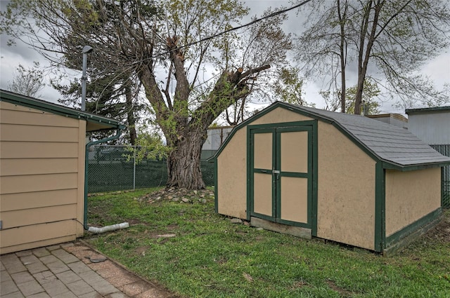 view of shed featuring fence