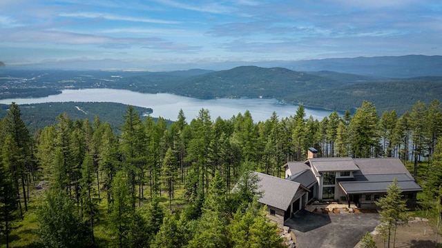 view of mountain feature featuring a water view and a wooded view