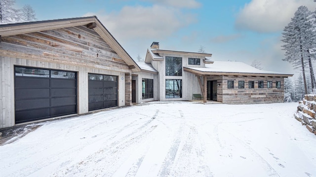 view of front of house with a garage and a chimney
