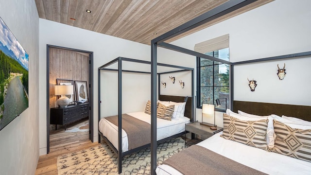 bedroom featuring wooden ceiling and wood finished floors