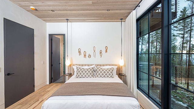 bedroom with wooden ceiling and wood finished floors