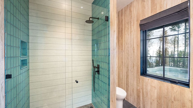 full bathroom featuring a stall shower and toilet