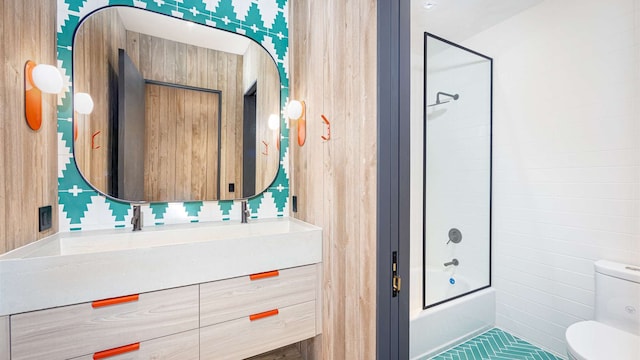 bathroom featuring vanity, shower / bathtub combination, and toilet