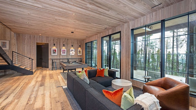 living area featuring wooden walls, wood ceiling, and hardwood / wood-style floors