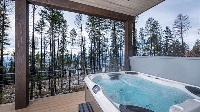 wooden deck featuring a hot tub