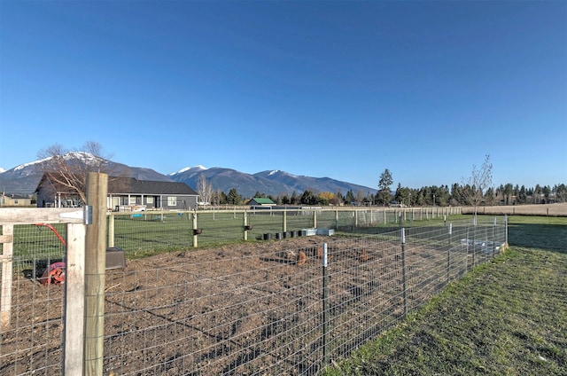 view of yard with a mountain view, a rural view, and fence