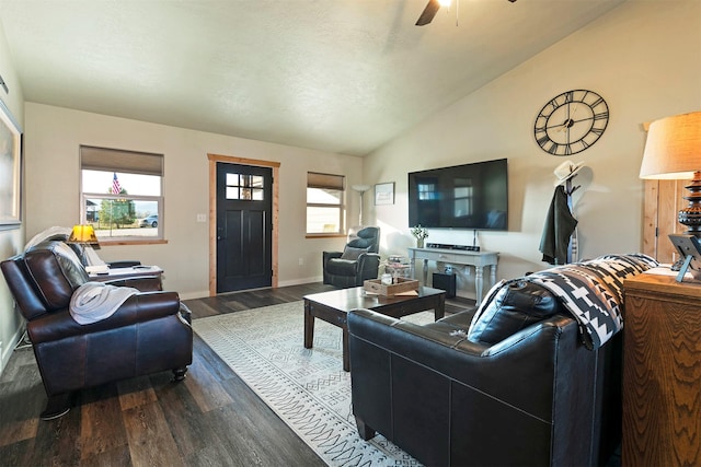 living room with baseboards, ceiling fan, vaulted ceiling, and dark wood-style floors