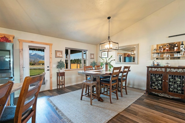 dining area featuring baseboards, vaulted ceiling, dark wood-style flooring, and a chandelier