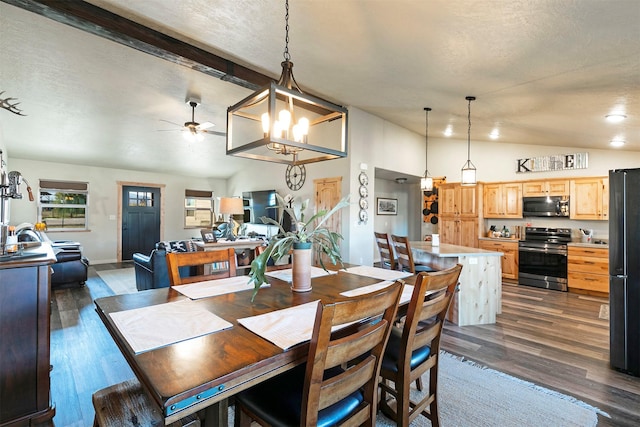 dining space with lofted ceiling with beams, dark wood-style floors, a healthy amount of sunlight, and ceiling fan with notable chandelier