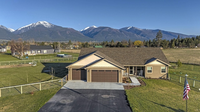 single story home with concrete driveway, fence, a front lawn, and a garage