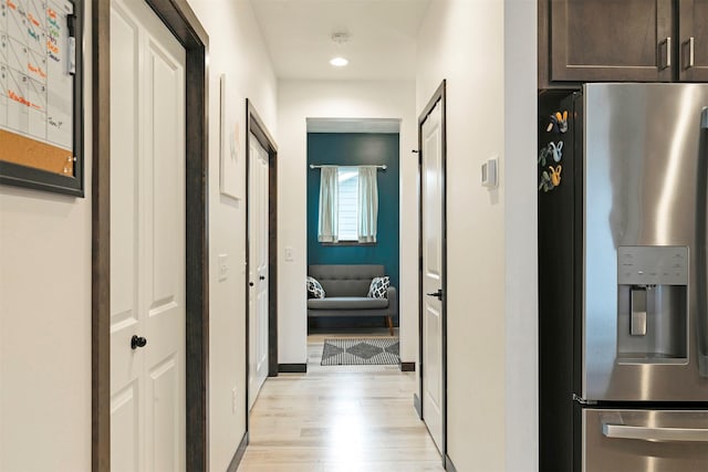 hall featuring recessed lighting, baseboards, and light wood-type flooring