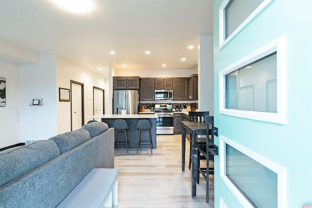living room featuring recessed lighting and light wood-style flooring