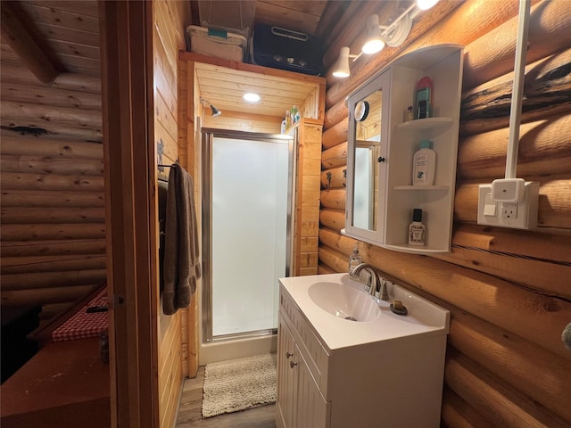 557 Crows Nest Main St, Haugan, MT 59842 - full bathroom featuring vanity, rustic walls, a stall shower, and wood finished floors