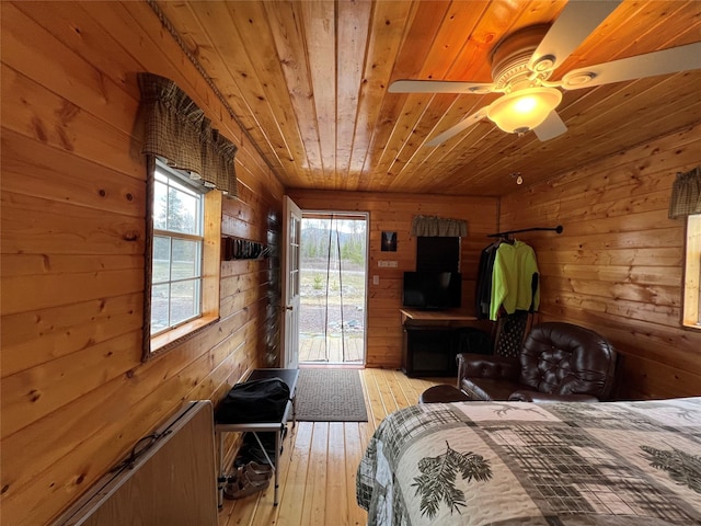557 Crows Nest Main St, Haugan, MT 59842 - bedroom featuring access to outside, wood walls, wood ceiling, and light wood-style floors
