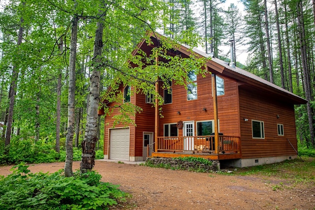 view of front of property with crawl space, a deck, driveway, and a garage