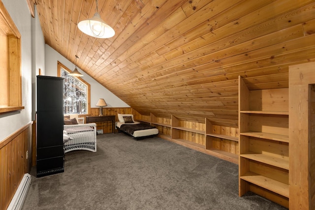 bedroom with baseboard heating, vaulted ceiling, a wainscoted wall, dark colored carpet, and wooden walls